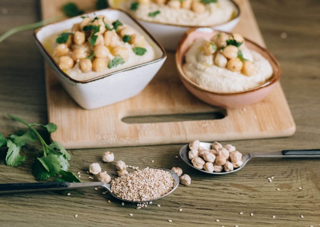 houmous maison avec des pois chiche et du sésame posé dans des cuillères